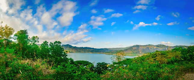panoramic landscape of natural views of lakes surrounded by mountains in Indonesia on a sunny morning
