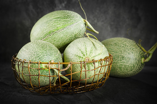 Fresh honeydew melon on dark background