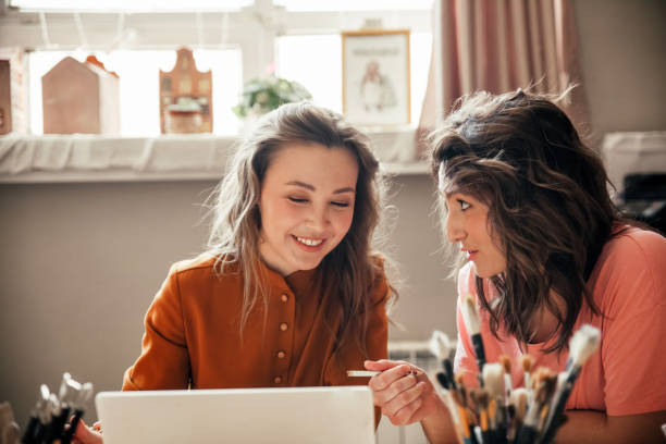 istock Two young female entrepreneurs sit with laptop in their workshop 1888737011