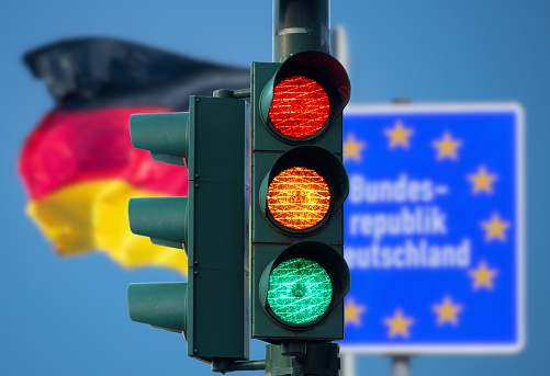 A traffic light and flag of Germany