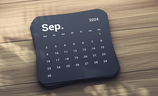 2024 September Calendar On Wood table with tree shadow