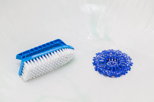 istock cleaning a white bathtub using household chemicals. 1888890874
