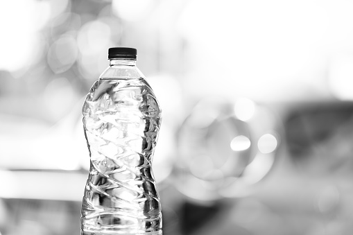 Close-up drinking water bottle with copy space, black and white scene