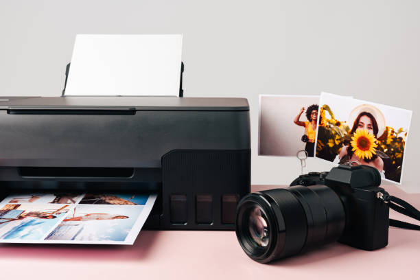 istock Printer and photo camera on table. Printing photos concept 1888915824