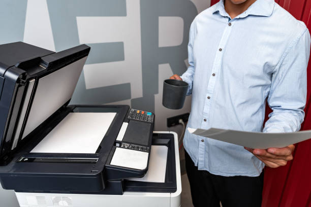 istock Unrecognizable businessman using printer in the modern office close up 1888960688
