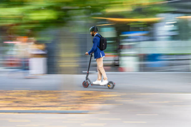istock Man riding his e-scooter on road in city 1888989101