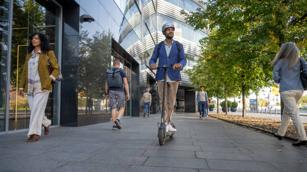 istock Man riding his e-scooter on road in city 1888989635