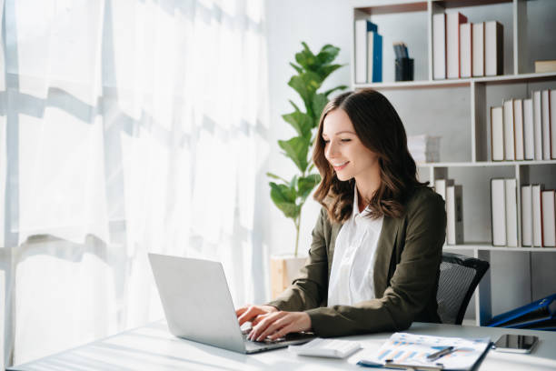 istock Woman freelancer is working her job on computer tablet and laptop Doing accounting analysis report real estate investment data, Financial at office 1888995350