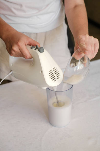 istock woman whipping cream with a mixer adding sugar close-up 1888998574