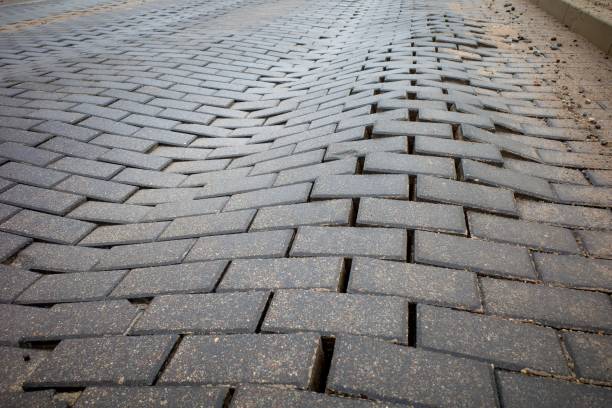 istock Defect in the road surface of artificial paving stones. Damage to the road surface. 1889022921