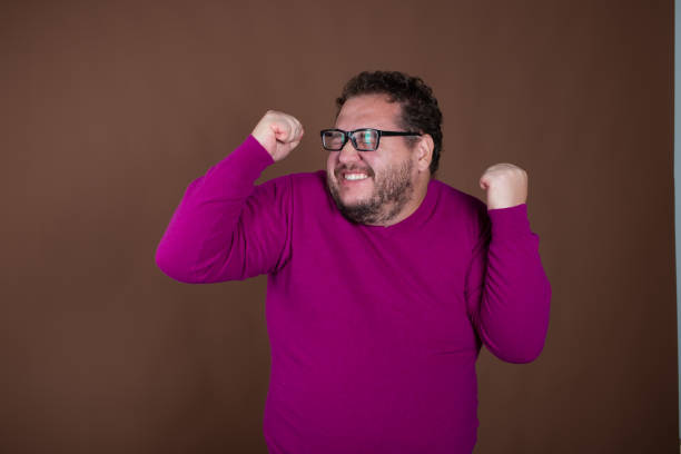 istock Funny fat man posing in studio on brown background. Different emotions. 1889023453