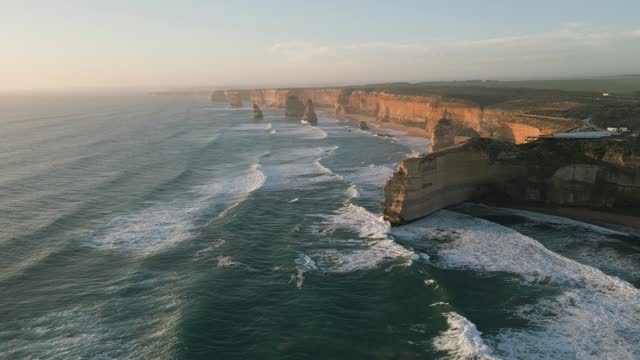 Stunning aerial drone view of the Twelve Apostles, a collection of limestone stacks & tourist attraction off the shore of Port Campbell National Park, by the Great Ocean Road in Victoria, Australia