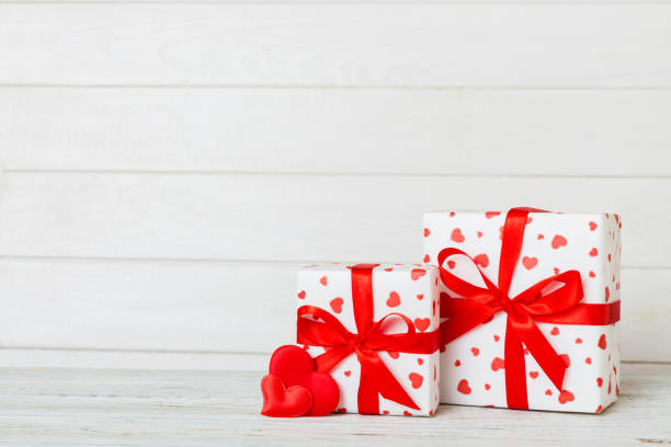 istock gift box with red bow and red heart on colored background. Perspective view. Flat lay 1889067905