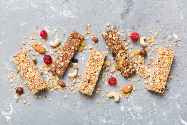 istock Various granola bars on table background. Cereal granola bars. Superfood breakfast bars with oats, nuts and berries, close up. Superfood concept 1889068476