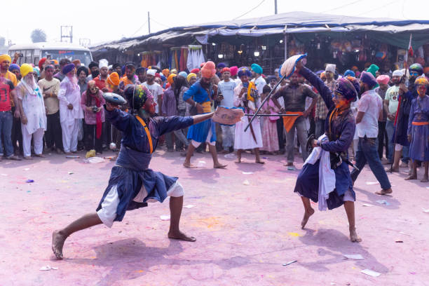 Sikh people performing martial art during hola mohalla stock photo