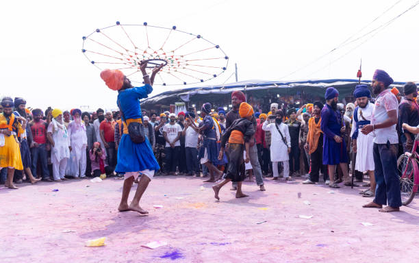 Sikh people performing martial art during hola mohalla stock photo