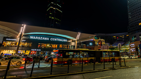 Warsaw, Poland - December 26, 2023: View on the Central Train Station with blurred shapes of moving vehicles in a foreground.