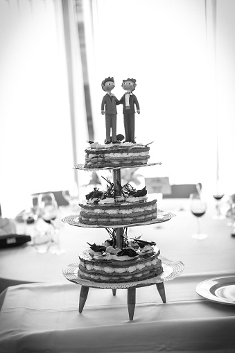 groom doll and statue is running away but bride can catch him finally. the funny wedding story doll on the top of cake with isolated object on white background and clipping path.