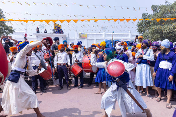 Sikh people performing martial art during hola mohalla stock photo