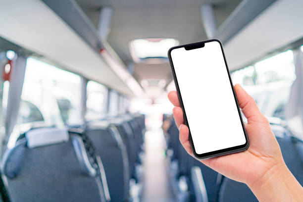 istock Hand holding blank screen phone in public bus interior 1889168487