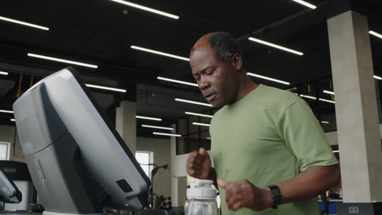 Black Man Using Treadmill in Gym