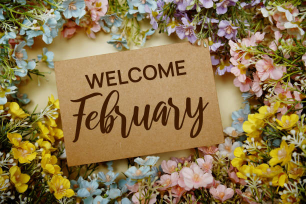 istock Welcome February text message with flower decoration on yellow background 1889186640