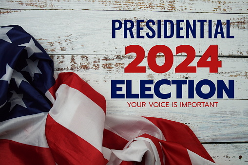 American flag with Presidential election 2024 text top view on wooden background