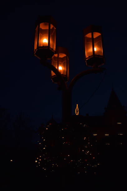 istock three street lights and a Christmas candle 1889200693