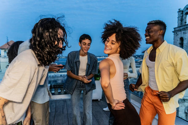 istock Friends dancing and having fun on the rooftop 1889221478