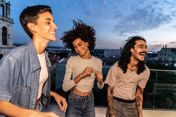 istock Friends dancing and having fun on the rooftop 1889224069