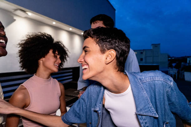 istock Friends talking and having fun during party on the rooftop 1889224073