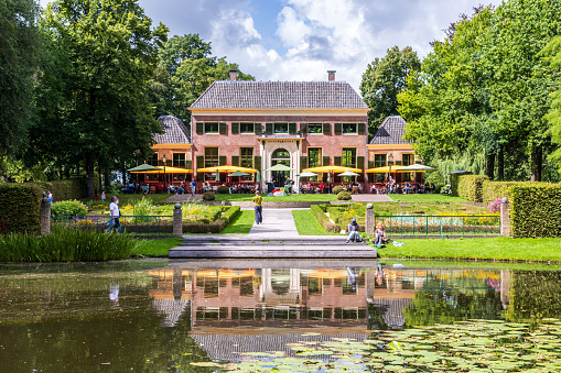 Rotterdam, Netherlands - July 30, 2023: Front view of Dudok in Het Park, a brasserie restaurant in Het Park public park housed in a 1750 historic monument with a french formal garden.