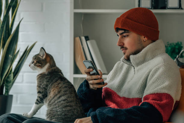 istock young man at home with pet cat 1889249096