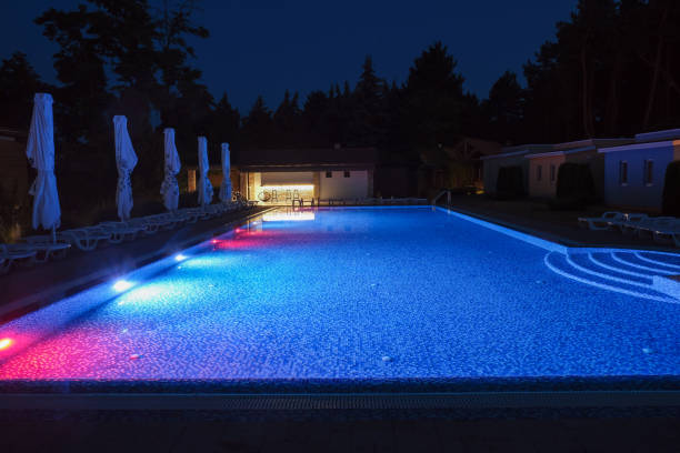 istock Summer outdoor pool with lighting at night. 1889324773