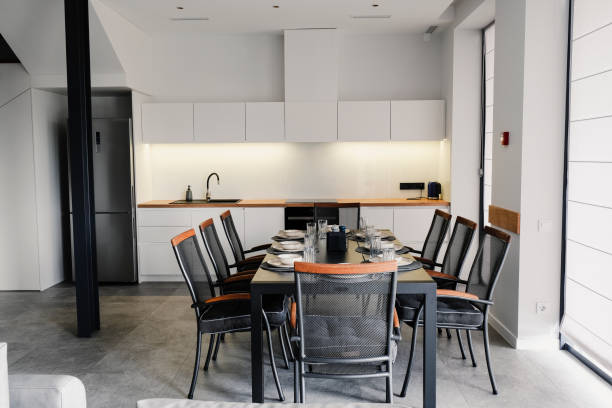 istock Modern dining table with chairs against the backdrop of kitchen furniture 1889324788