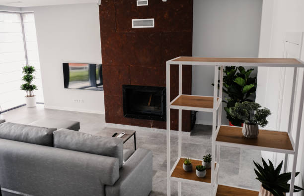 Interior of a modern living room with a sofa, fireplace and artificial flowers.