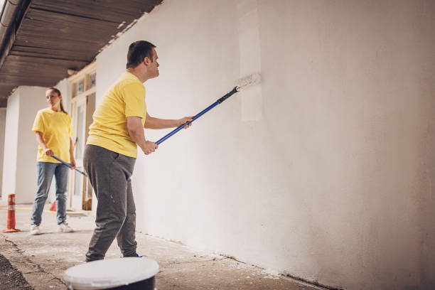 istock Volunteers renovating wall together 1889326437