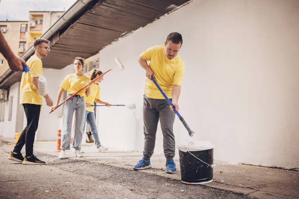 istock Volunteers renovating wall together 1889332639