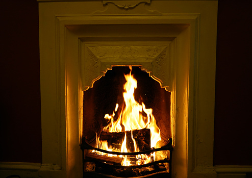 Close up of a open fireplace burning in a house