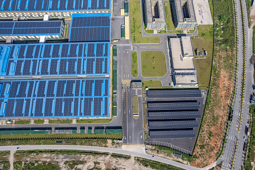 Solar panels on the roofs of large factories by the seaside