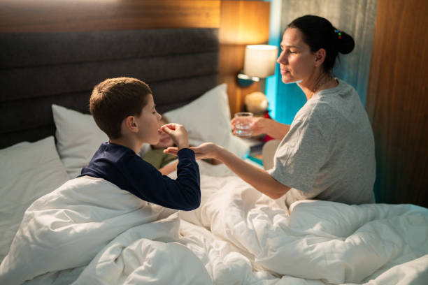 istock Mom with kids in bed 1889438212