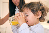 Little boy drinking orange juice