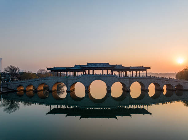 istock The calm lake surface and arch bridge 1889480273