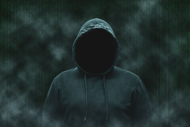 istock Mysterious faceless hooded anonymous computer hacker, silhouette of cybercriminal, terrorist 1889484268