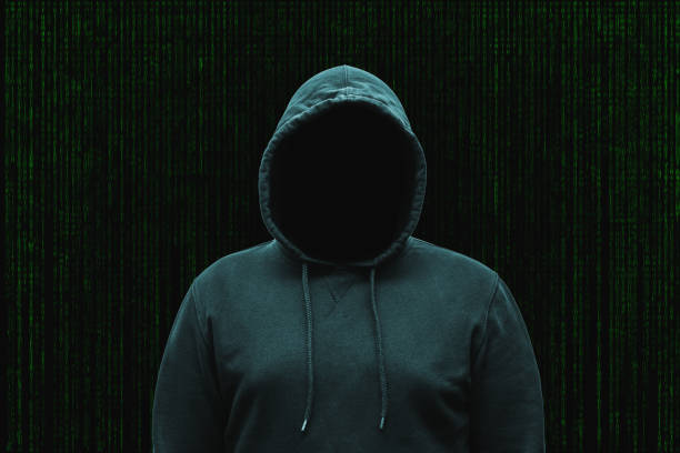 Mysterious faceless hooded anonymous computer hacker, silhouette of cybercriminal, terrorist