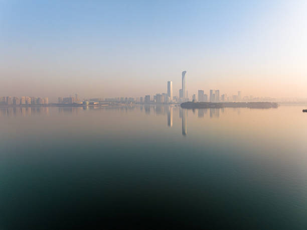 istock The calm lake surface and urban architecture 1889487395