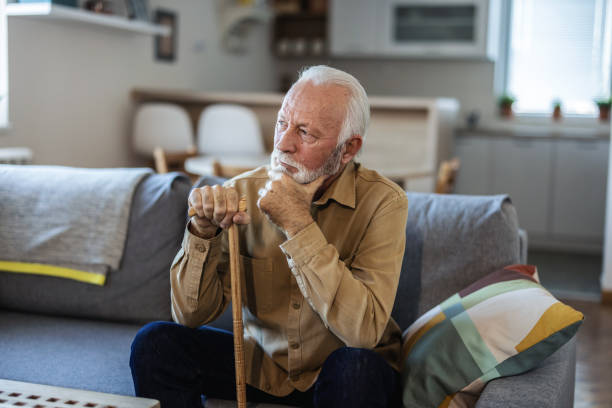 istock Thoughtful elderly man sitting alone at home with his walking cane. 1889501544