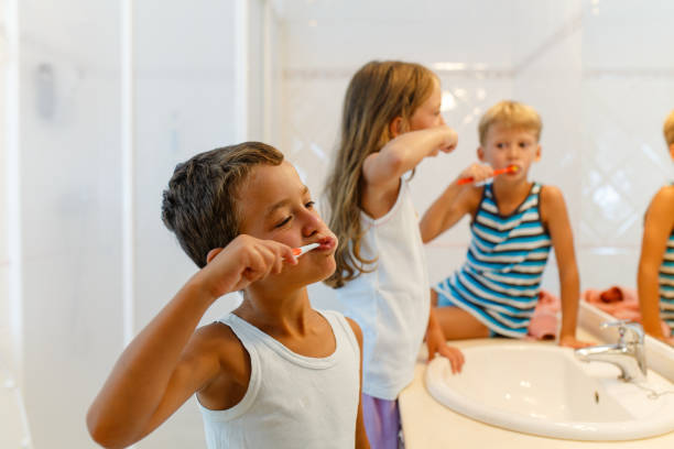 istock Children brushing teeth in the bathroom together 1889504665