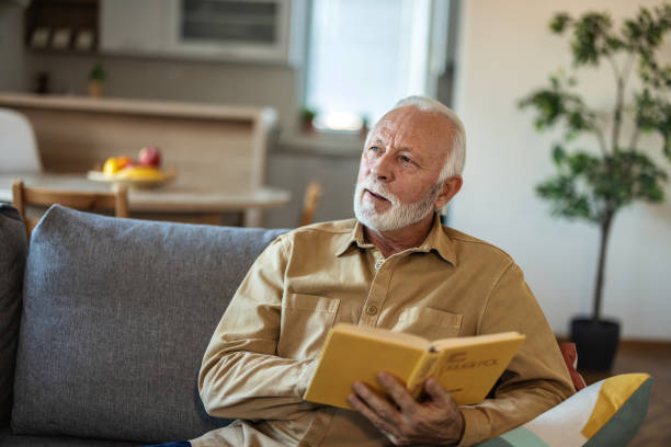 istock Senior men enjoying time at home by reading his favorite book. 1889505921