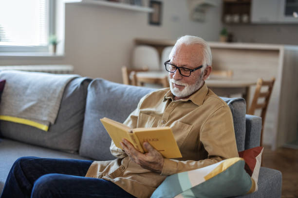 istock Cropped shot of a handsome senior man reading a book while working in his study. 1889508819
